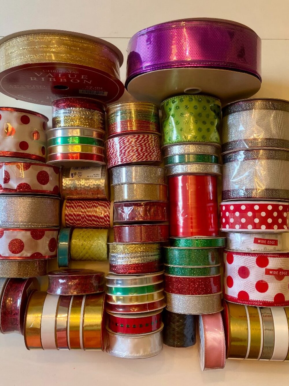 Bulk lot of mixed gift ribbon, new, unopened, original packaging, over 1,500'.